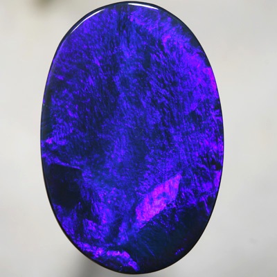 SOLID BLACK OPAL Very Large blue on black, Broad electric rolling flash. SEE VIDEO